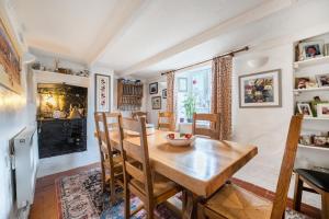 a dining room with a wooden table and a fireplace at Redmoor in Saint Day +6 photos