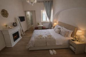 a bedroom with a large bed and a fireplace at Affittacamere Silvagni in Caserta