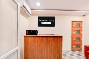 a room with a counter with a microwave on the wall at Townhouse MVP Sector With Kailasagiri Hill View in Visakhapatnam +35 photos