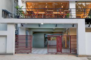 a building with a red door and a balcony at Townhouse MVP Sector With Kailasagiri Hill View in Visakhapatnam
