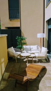 a patio with couches and tables on a building at El Rincón del Ángel in Jaca