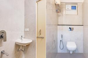 a bathroom with a sink and a toilet and a shower at Townhouse MVP Sector With Kailasagiri Hill View in Visakhapatnam