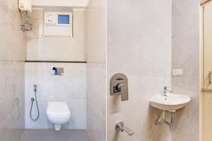 a bathroom with a toilet and a sink at Townhouse MVP Sector With Kailasagiri Hill View in Visakhapatnam