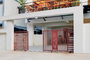a red gate on the side of a building at Townhouse MVP Sector With Kailasagiri Hill View in Visakhapatnam