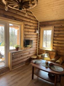 a living room with a couch and a table at Miško sodyba in Gedvainiai