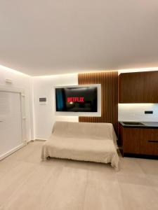 a bedroom with a bed and a tv on the wall at Alexis Suites Olympus in Litochoro +16 photos