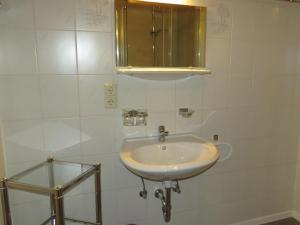 a white bathroom with a sink and a mirror at Ferienwohnung Birgit in Sankt Gallenkirch