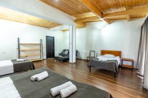 a large room with two beds and a wooden ceiling at Mestia HOTEL AMIRANI in Mestia +37 photos