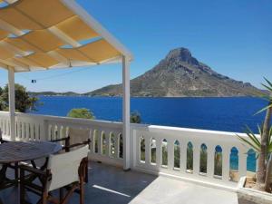 a patio with a table and a view of the ocean at Louis Studios Armeos in Masouri