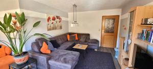 a living room with a couch and a table at FEWO Aschbergblick in Klingenthal