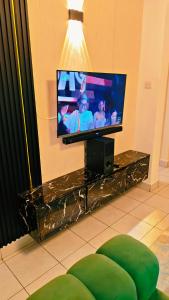 a flat screen tv sitting on top of a table at Shima Complex in Nakuru +2 photos