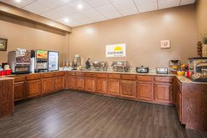 a restaurant with a counter and aacistacistacistacistacist at Days Inn by Wyndham Joplin in Joplin