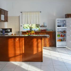 a kitchen with a counter with fruit on it at Blue Sky Apartment in Soufrière