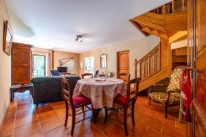 a dining room with a table and chairs at La Maison de Piquereau in Sauveterre-de-Guyenne