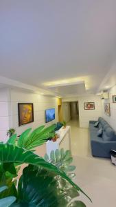 a living room with a couch and a blue sofa at Hotel Anantha Suites in Sitam Petta
