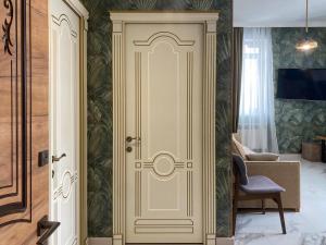 a white door in a room with a chair at S-Van Cozy Home in Sevan