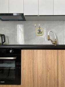 a kitchen counter with a sink and a stove at S-Van Cozy Home in Sevan