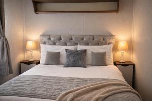 a bedroom with a large bed with two lamps at Rosie's Seton Retreat in Port Seton