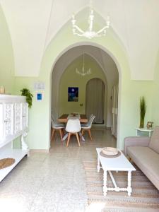 a living room with a table and a couch at Casa Salento Diso in Diso