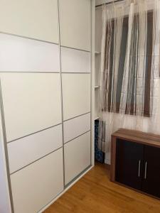 a closet with white cabinets and a wooden table at Risinium sun in Risan