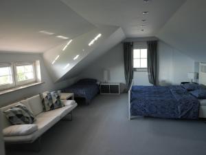 a bedroom with a bed and a couch at Vineyard cottage SkyView in Semič
