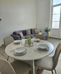 a table in a living room with plates and wine glasses at Atomium Apartment 1 in Brussels