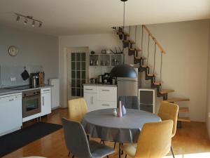 a kitchen and dining room with a table and chairs at Vineyard cottage SkyView in Semič