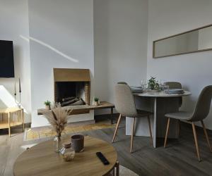 a living room with a table and a fireplace at Atomium Apartment 1 in Brussels