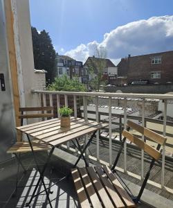a wooden table and two chairs on a balcony at Atomium Apartment 1 in Brussels