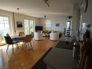 a kitchen and living room with a table and chairs at Vineyard cottage SkyView in Semič