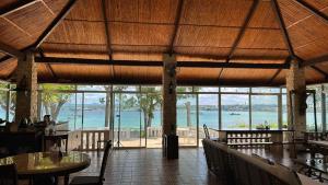 a restaurant with tables and a view of the ocean at Seaside Villa in Dauis
