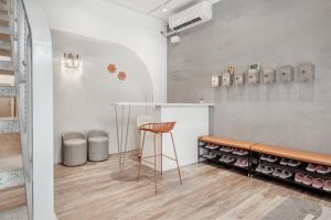 a tasting room with a stool and wine bottles at Wuyu in Tainan
