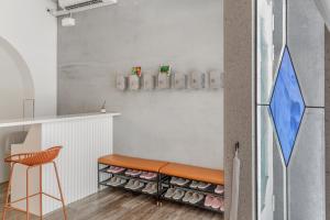 a bar with a bench and a stool in a room at Wuyu in Tainan