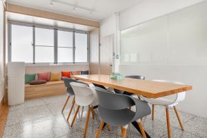 a dining room with a wooden table and chairs at Wuyu in Tainan
