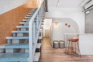 a staircase with blue treads in a room with a stool at Wuyu in Tainan +49 photos