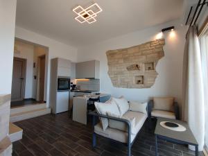 a living room with a couch and a table at Alexena Apartments in Agia Galini +28 photos