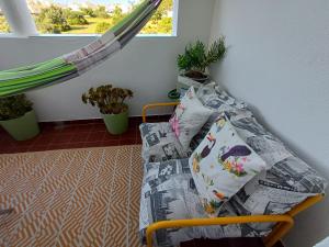 a bed in a room with pillows on it at Quarto Casa na Praia in Porches
