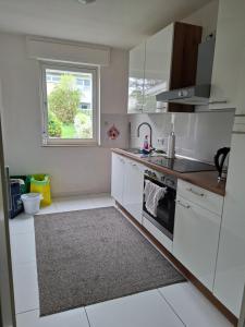 a kitchen with white appliances and a window at Pension Rückert in Kassel