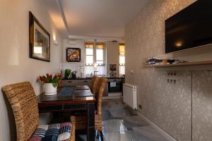 a kitchen with a table and chairs and a counter at Apartamenty Boutique in Ustka +33 photos