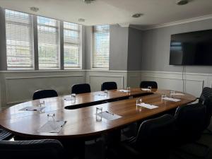 a conference room with a large wooden table and chairs at The Park Hotel in Liverpool