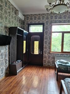 a room with a black door and a wooden floor at сой333 in Navoi