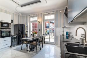 a kitchen with a table and chairs and a sink at Apartamenty Boutique in Ustka