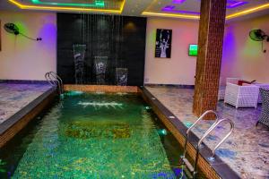 a large pool of water in a hotel room at Soulmate Hotels and Suites in Mawere