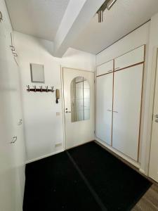 a room with white walls and a hallway with a door at Pohjankaira in Rovaniemi