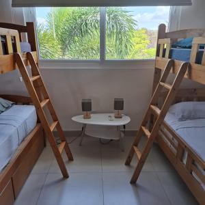 a room with two bunk beds and a table with two lamps at Rio Mar Villages in San Carlos +11 photos