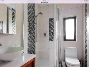a bathroom with a sink and a toilet and a shower at Hadrian House in East Preston +32 photos