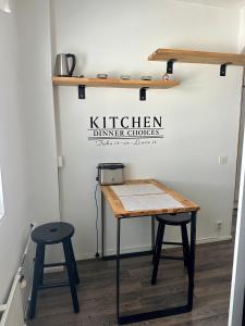a kitchen with a table and two stools at Pohjankaira in Rovaniemi