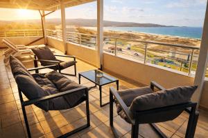 a balcony with chairs and a view of the ocean at Hotel Ancora Beach in Primorsko