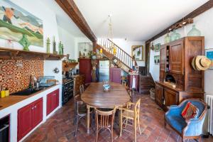 a kitchen with a wooden table and chairs at Maison de charme a Bayonne in Bayonne