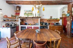 a kitchen with a wooden table and chairs at Maison de charme a Bayonne in Bayonne +20 photos